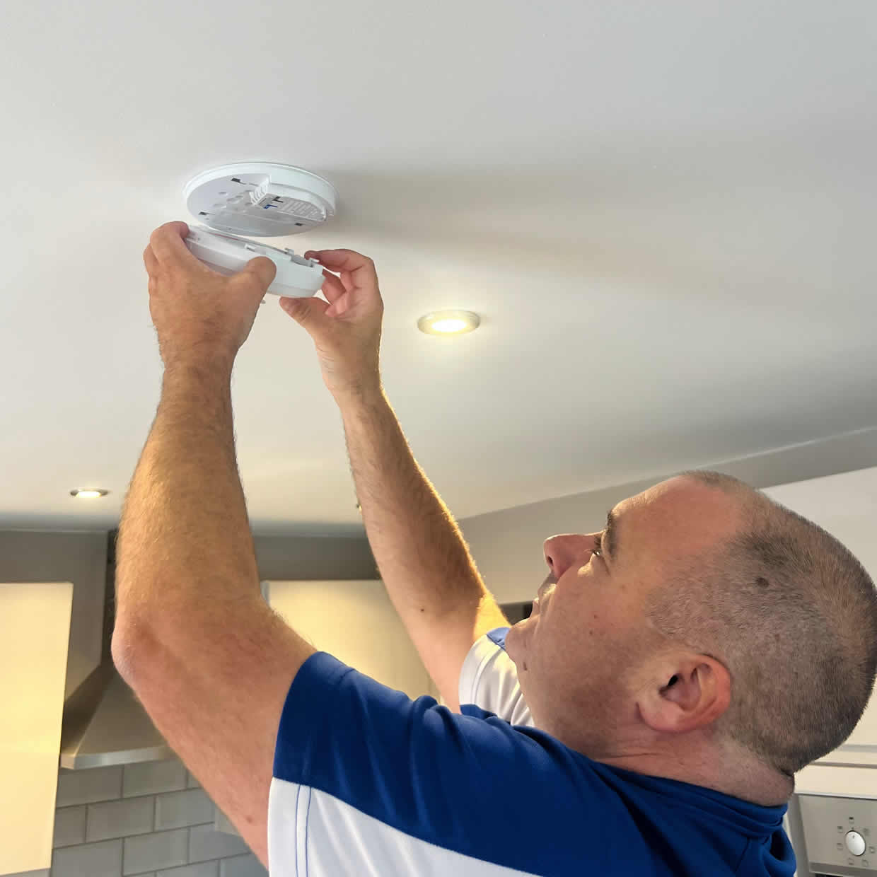 Smoke alarm being installed on a ceiling in Dudley